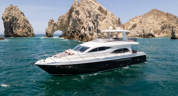Stylish 63ft sport yacht cruising across calm waters.